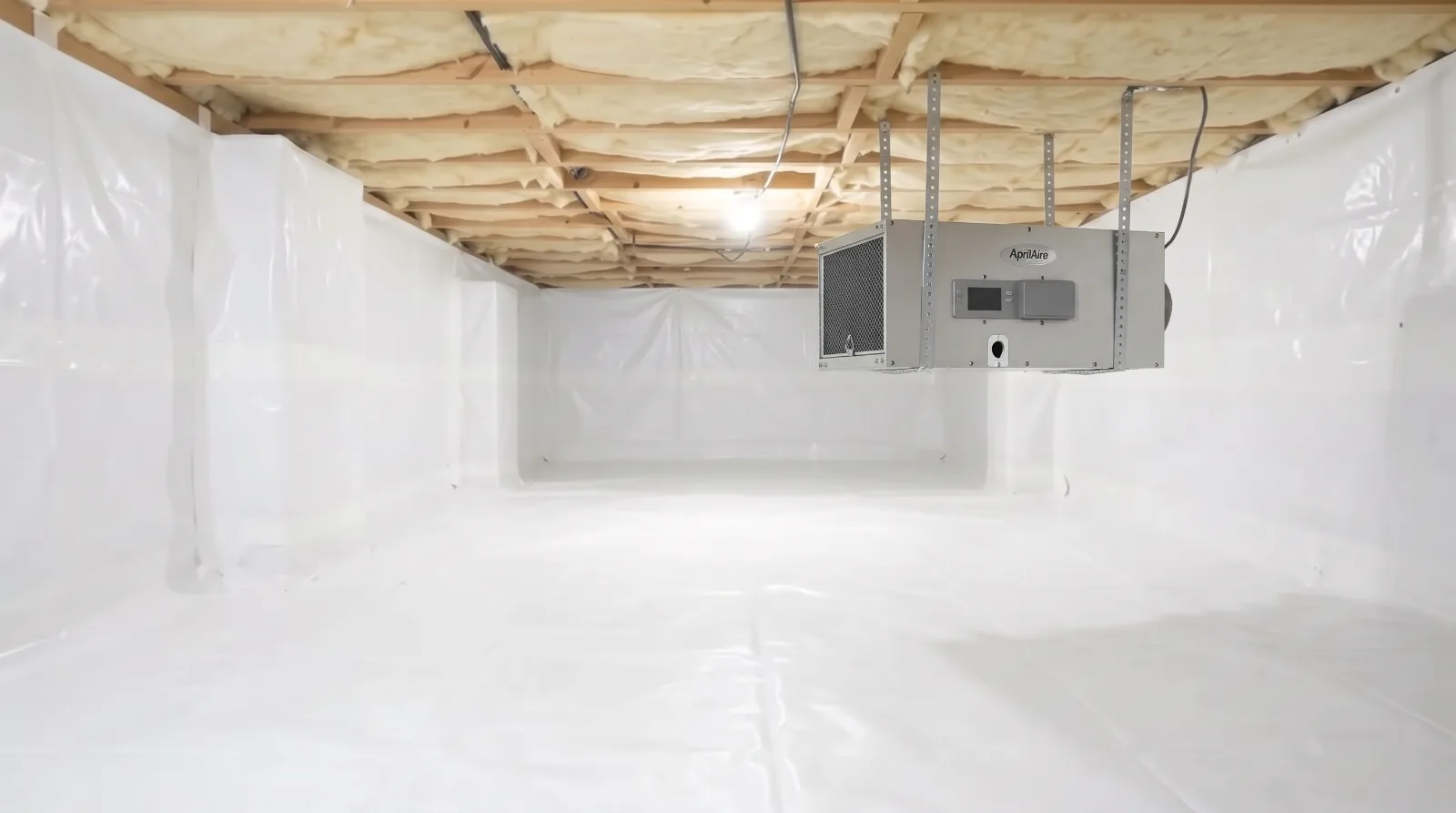 Fully encapsulated crawl space with white vapor barrier on the floor and walls, insulated joists and a ceiling-mounted dehumidifier