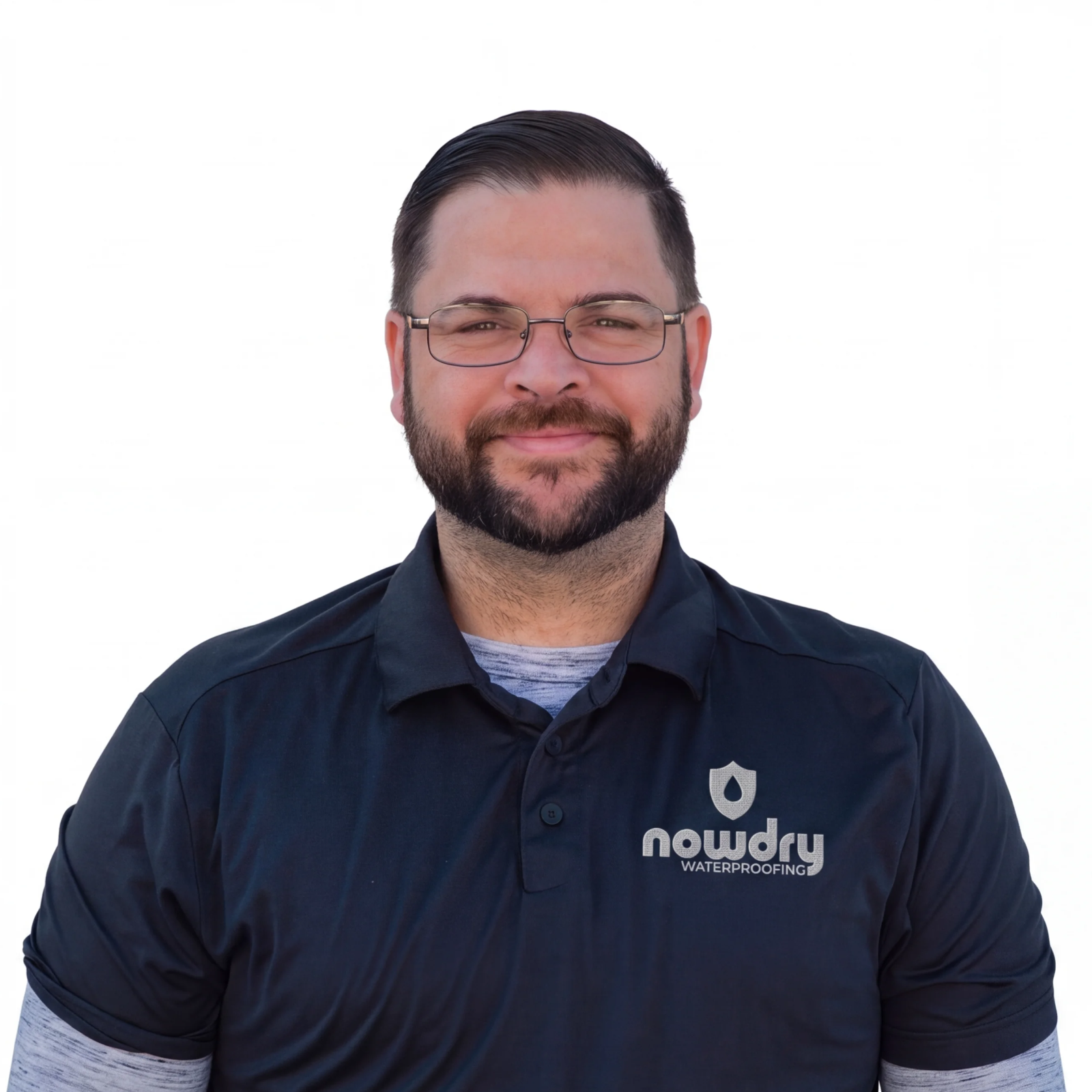 Matthew Miller, smiling in glasses and a navy NowDry polo against a white background